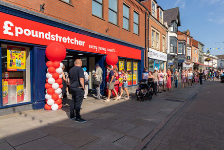 Shoppers wait outside the new Melton store