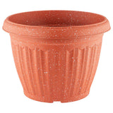 Speckled plastic garden pot in orange on a white background