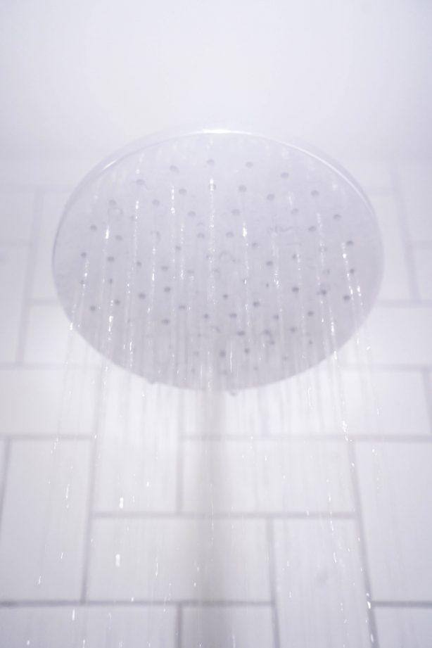 A shower head in a bathroom setting